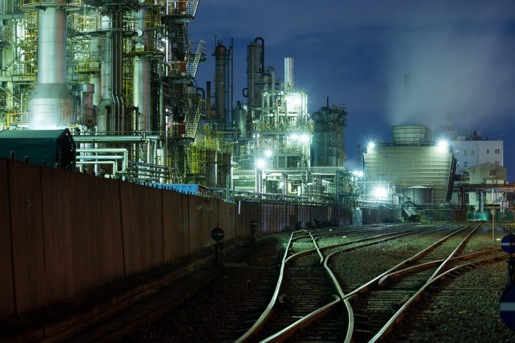 Heavy industrial processing plant at night with rail infrastructure – industrial construction and recruitment in WA and Queensland