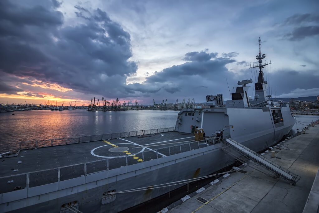 Naval defence vessel docked at port at sunset – defence and maritime recruitment across Western Australia and Queensland